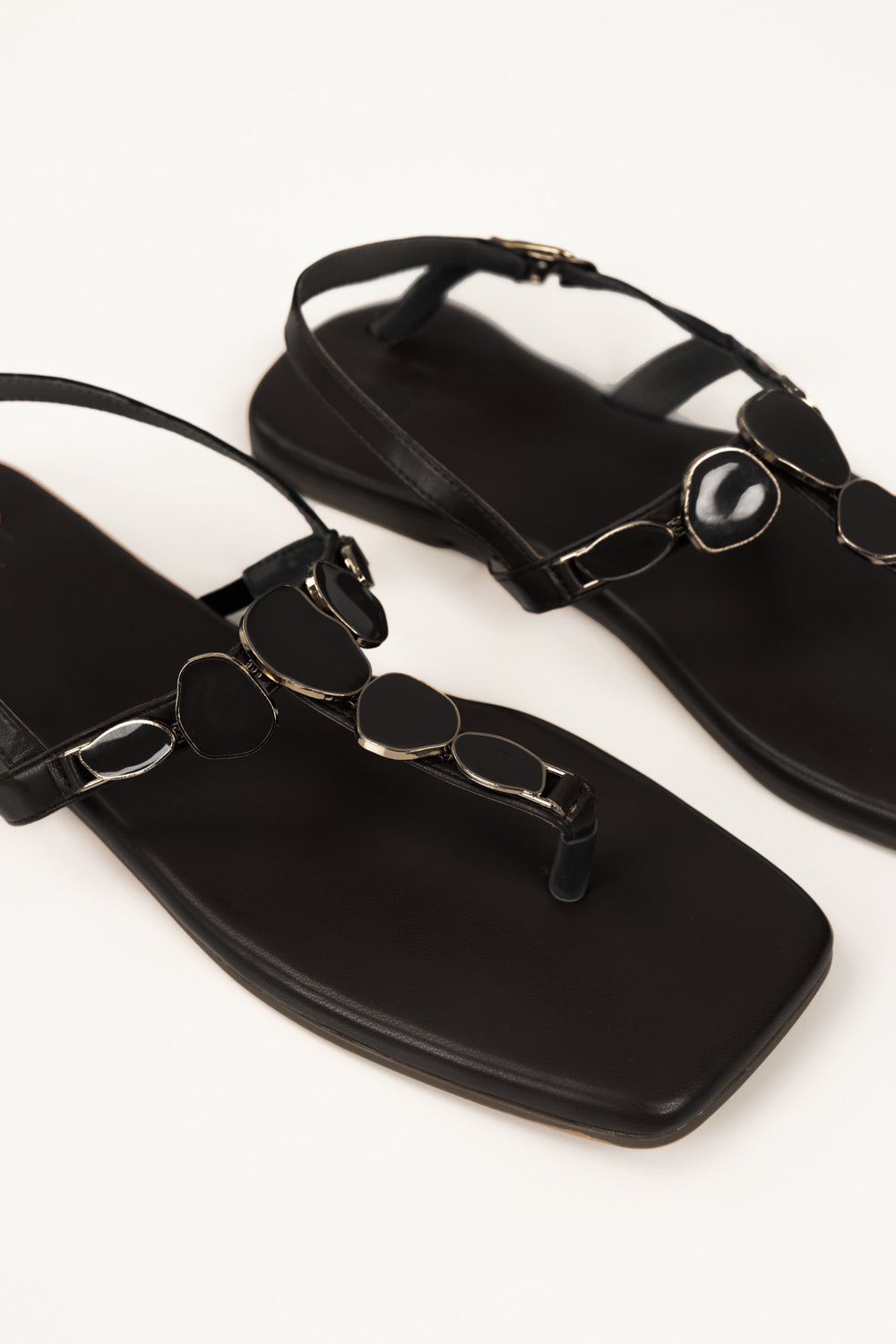 https://cdn.shopify.com/s/files/1/0706/3253/8159/files/467874-black-sandal-closeup1-ideas.jpg?v=1779690657