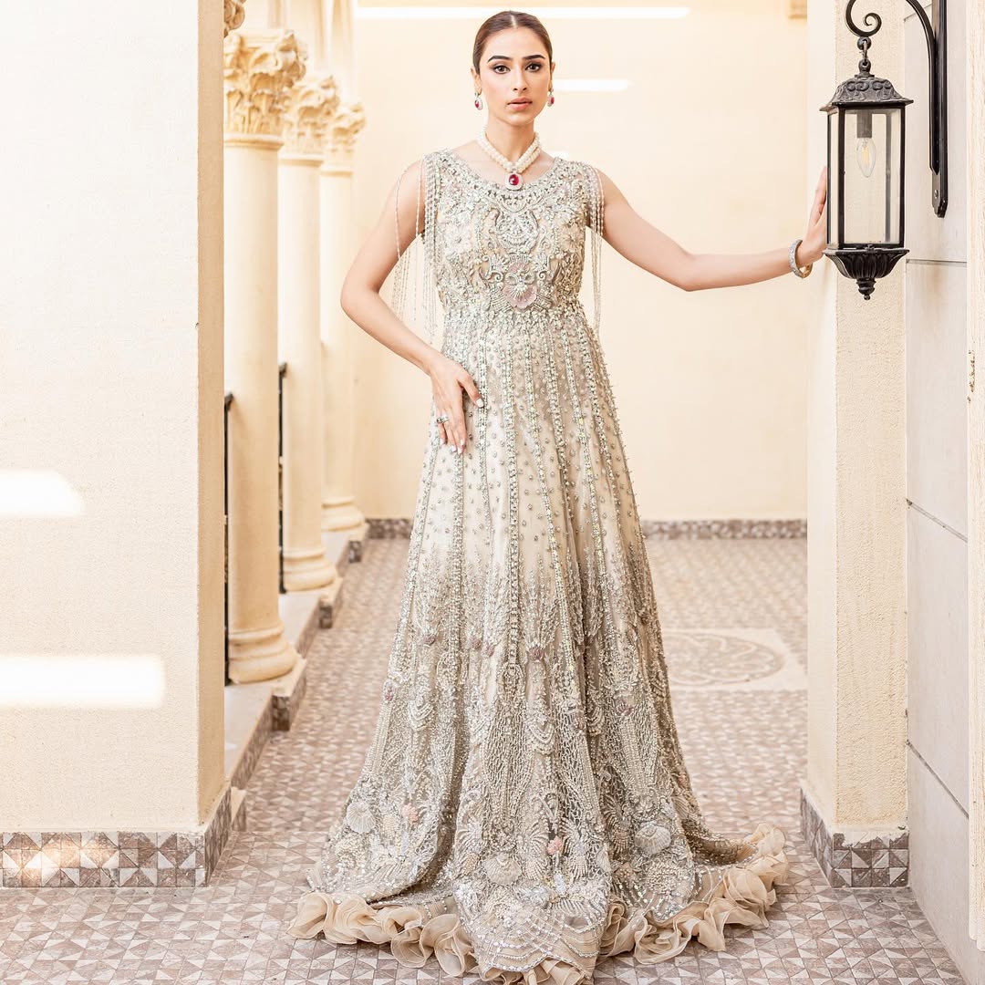 https://cdn.shopify.com/s/files/1/0523/4327/5696/files/Pakistani-bridal-outfit-Maia-champagne-gold-net-gown-mysie-1.jpg?v=1757929580
