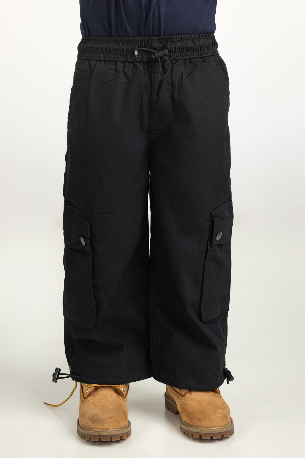 https://cdn.shopify.com/s/files/1/0706/3253/8159/files/Salt-Kids-Trousers-Color-Black-100_-Cotton-Cargo-Fit-TB-TRC-SS25-002-Front.jpg?v=1761636356