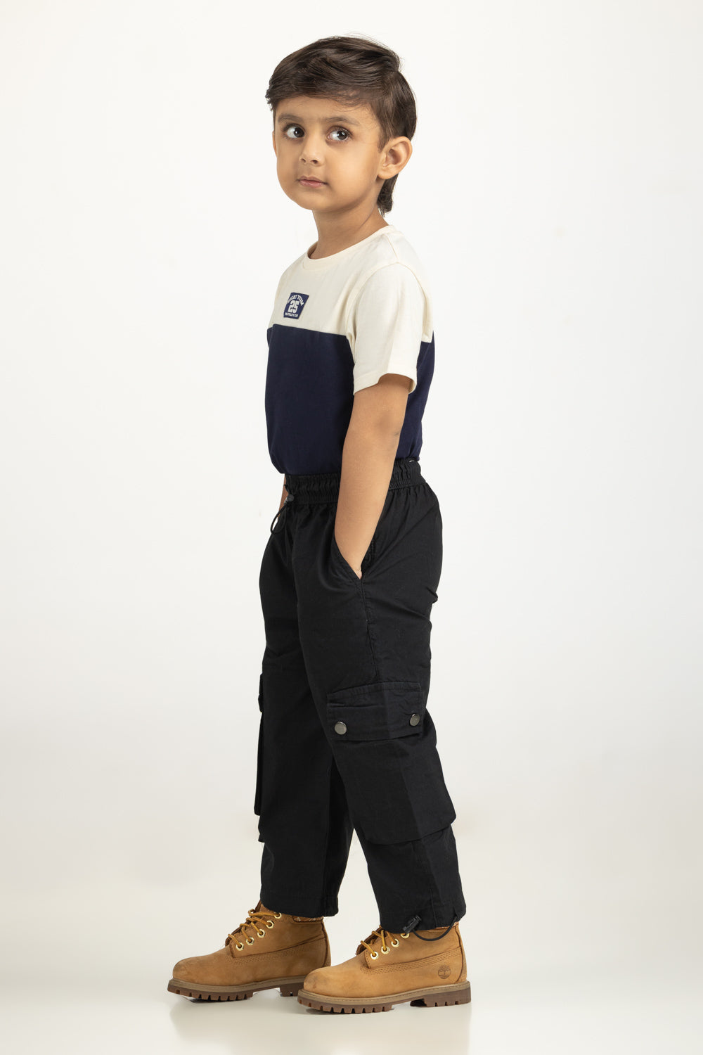 https://cdn.shopify.com/s/files/1/0706/3253/8159/files/Salt-Kids-Trousers-Color-Black-100_-Cotton-Cargo-Fit-TB-TRC-SS25-002-Left.jpg?v=1761636356