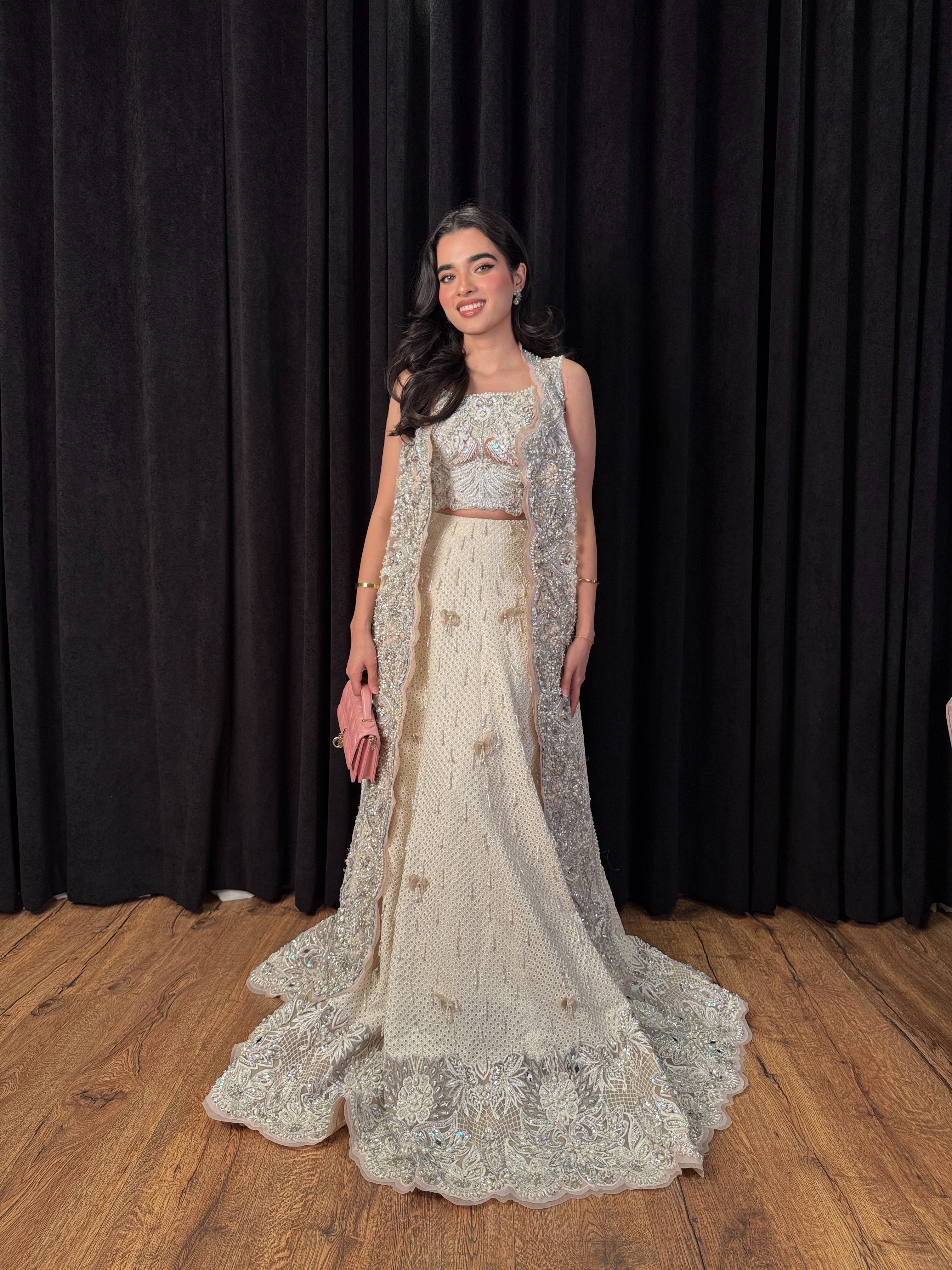 https://cdn.shopify.com/s/files/1/0523/4327/5696/files/mysie-by-tahira-minsa-ivory-net-lehenga-2.jpg?v=1757421756