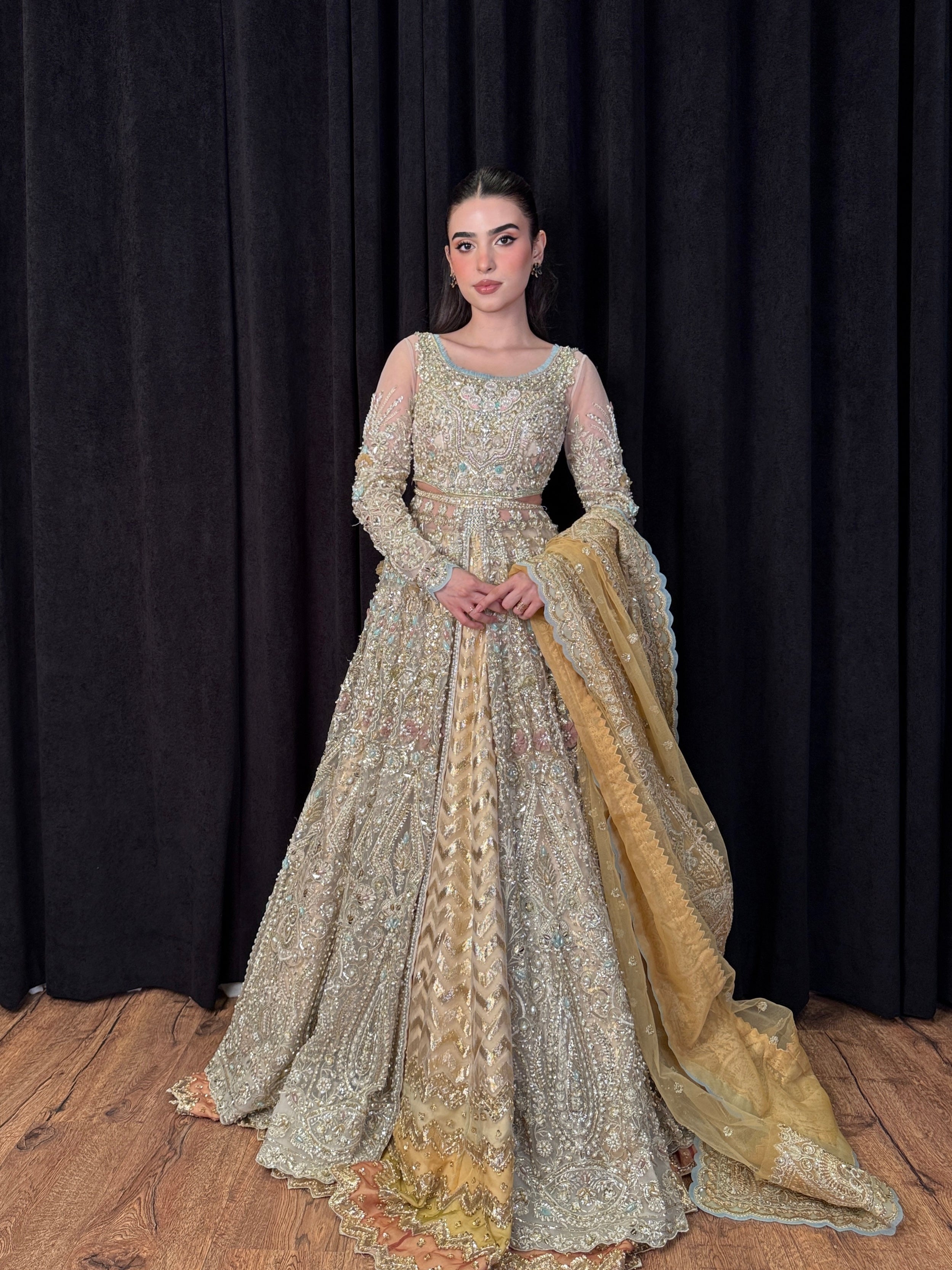 Designer champagne net gown with intricate handwork and gold dupatta – Tansa by Mysie by Tahira, Pakistani wedding wear.