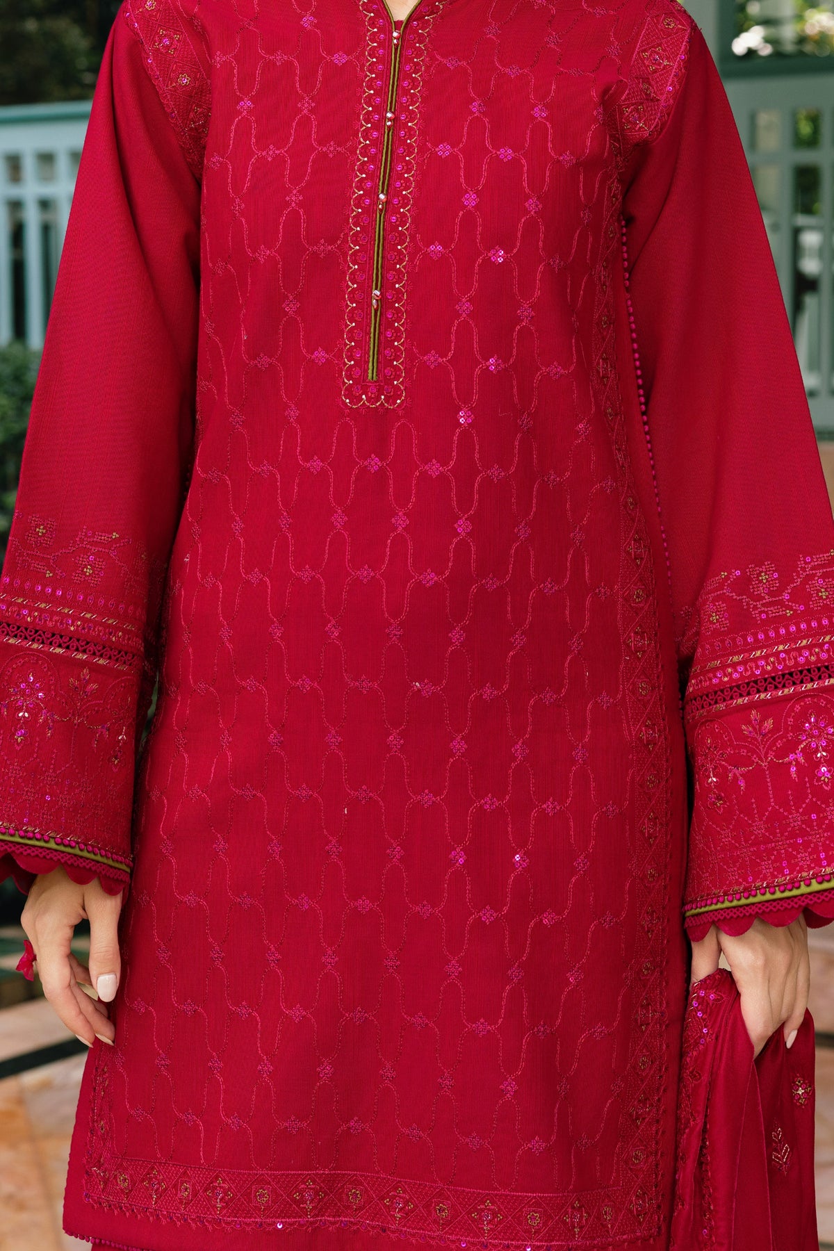 Red embroidered traditional outfit with a patterned design.
