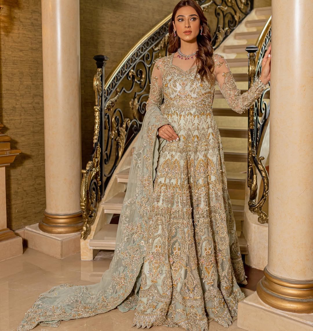 https://cdn.shopify.com/s/files/1/0523/4327/5696/files/Pakistani-bridal-outfit-Cleo-mint-green-frock-and-raw-silk-lehenga-mysie-3.jpg?v=1757927085