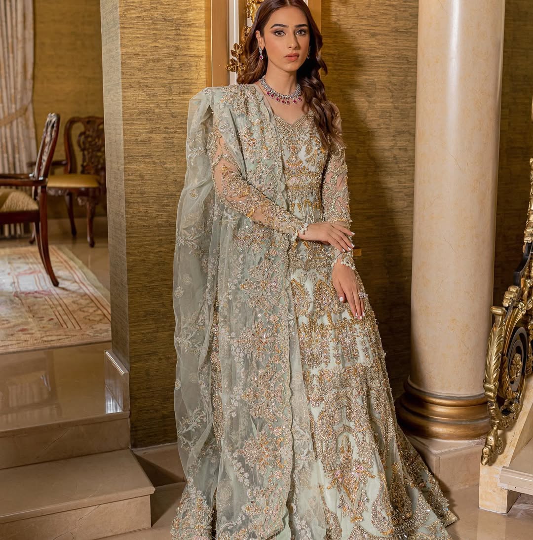https://cdn.shopify.com/s/files/1/0523/4327/5696/files/Pakistani-bridal-outfit-Cleo-mint-green-frock-and-raw-silk-lehenga-mysie-5.jpg?v=1757927085