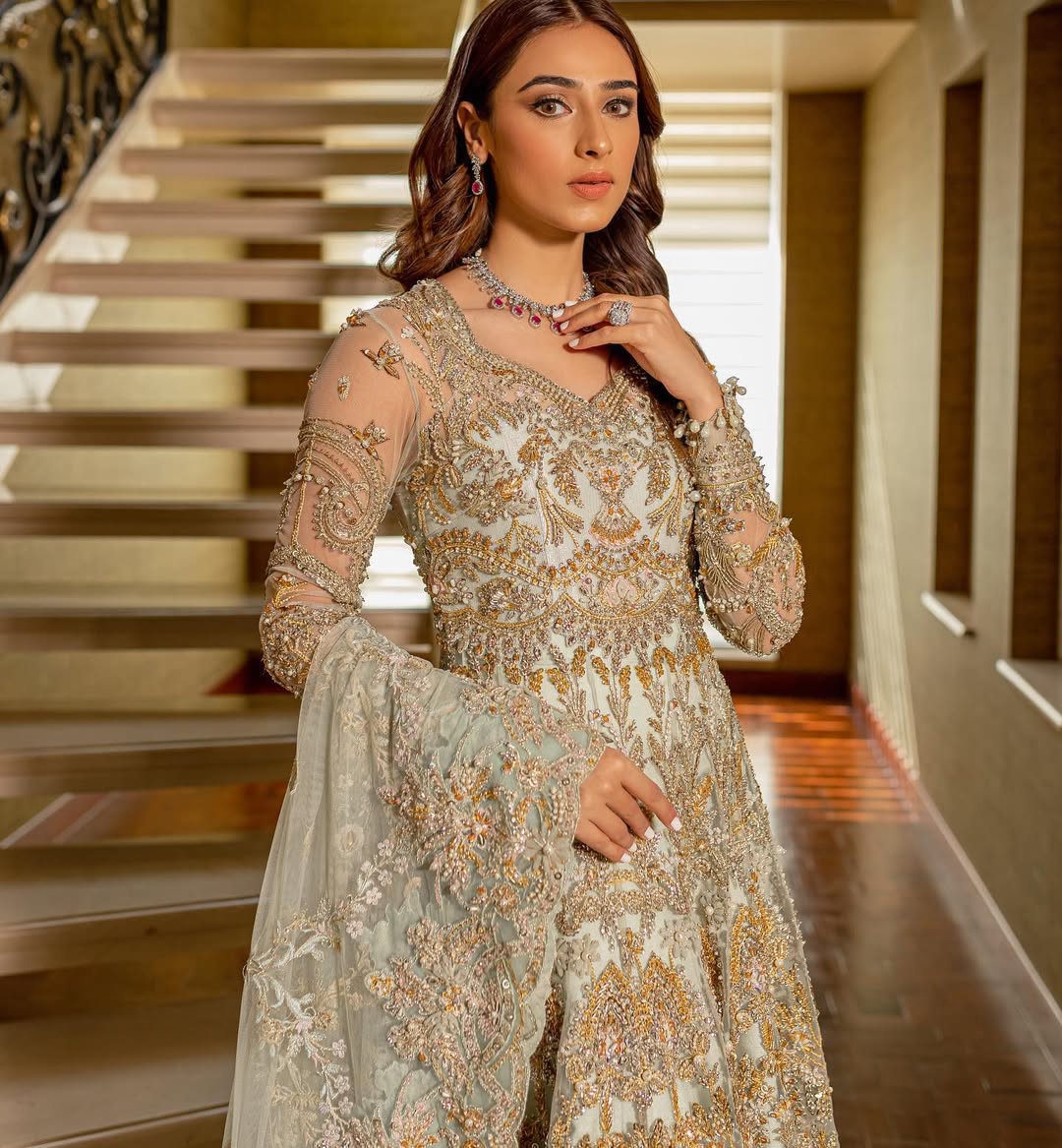 https://cdn.shopify.com/s/files/1/0523/4327/5696/files/Pakistani-bridal-outfit-Cleo-mint-green-frock-and-raw-silk-lehenga-mysie-8.jpg?v=1757927085
