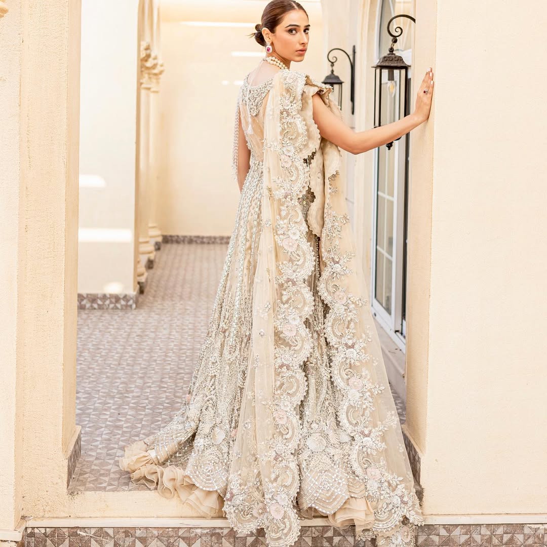 https://cdn.shopify.com/s/files/1/0523/4327/5696/files/Pakistani-bridal-outfit-Maia-champagne-gold-net-gown-mysie-8.jpg?v=1757929580