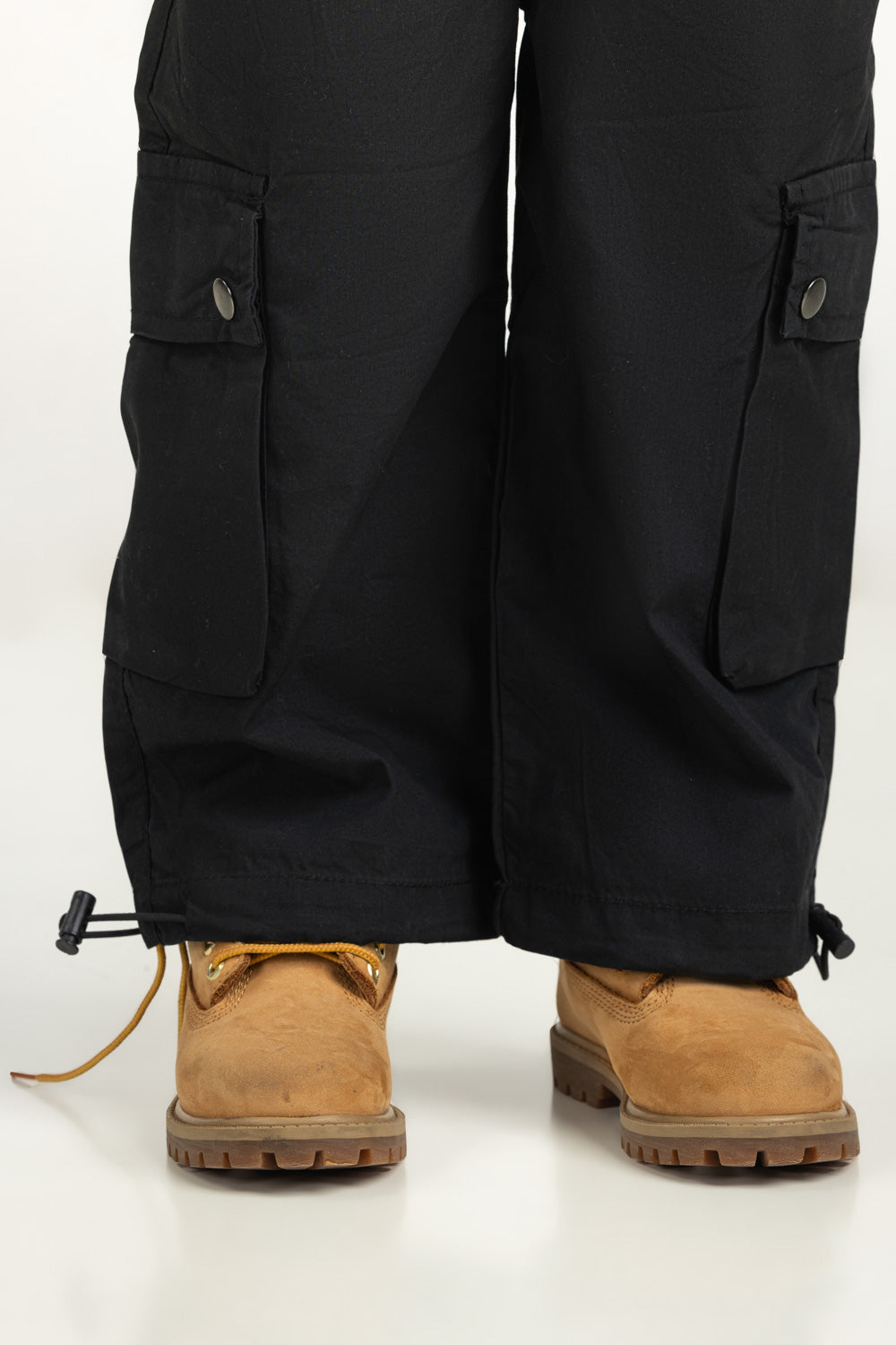 https://cdn.shopify.com/s/files/1/0706/3253/8159/files/Salt-Kids-Trousers-Color-Black-100_-Cotton-Cargo-Fit-TB-TRC-SS25-002-Zoom-2.jpg?v=1761636242
