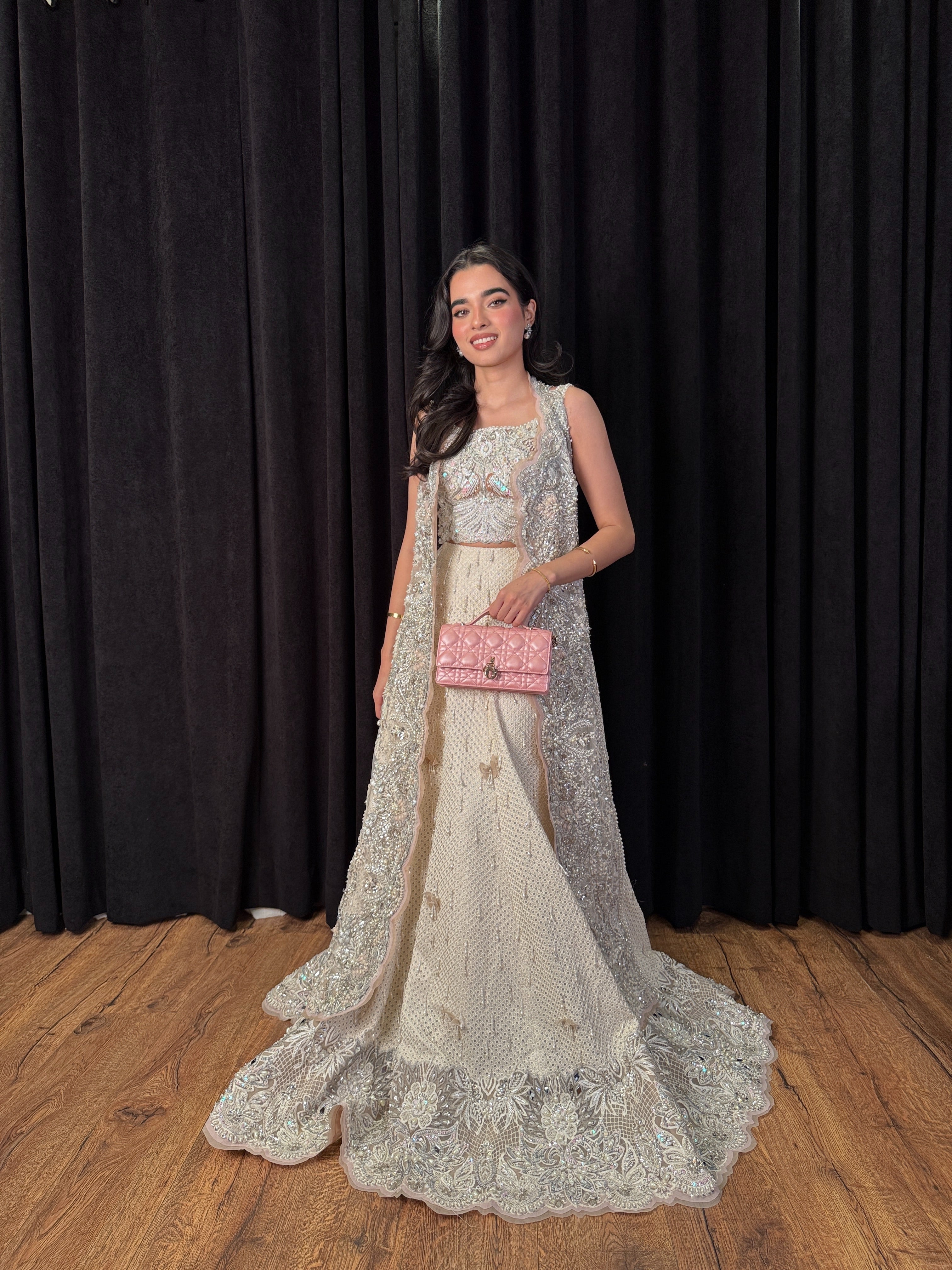 https://cdn.shopify.com/s/files/1/0523/4327/5696/files/mysie-by-tahira-minsa-ivory-net-lehenga-3.jpg?v=1757421769